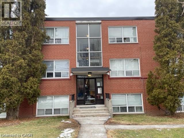 A red brick building with a glass entrance and a sign that says REALTOR.