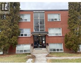A red brick building with a glass entrance and a sign that says REALTOR.