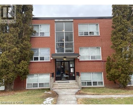 A red brick building with a glass entrance and a sign that says REALTOR.
