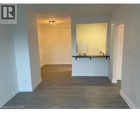 A room with a white wall and a wooden floor.