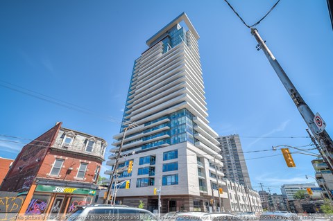 A tall building with a crane in front of it.