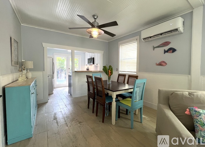 A dining room with a table and chairs.