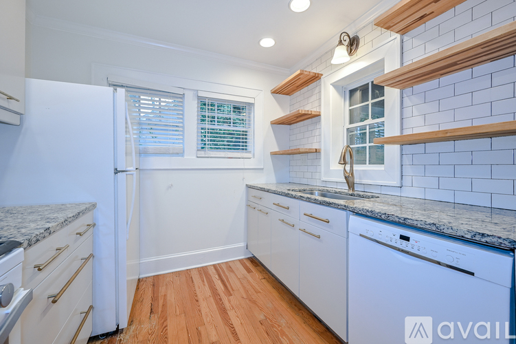 A kitchen with white appliances and wooden shelves.