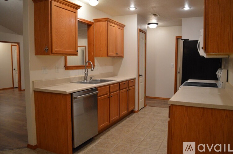 A kitchen with wooden cabinets and a white countertop.