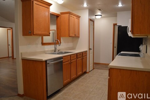 A kitchen with wooden cabinets and a white countertop.