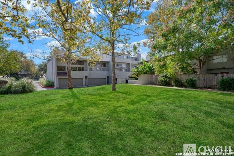 A well-maintained lawn in front of a residential building.
