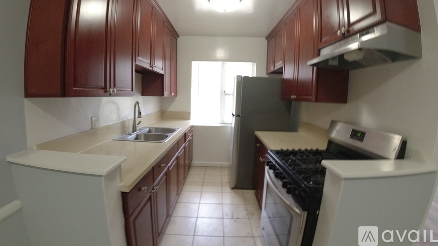 A kitchen with brown cabinets and a stove top oven.