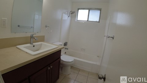 A bathroom with a sink, toilet, and bathtub.