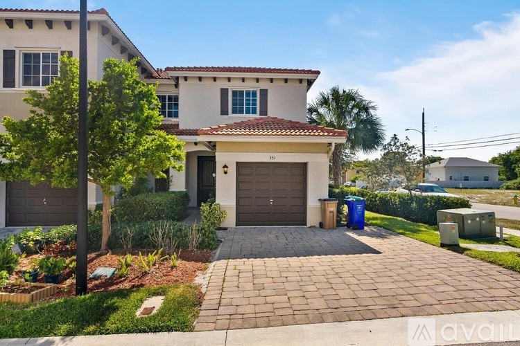 A house with a red tile roof and a driveway.