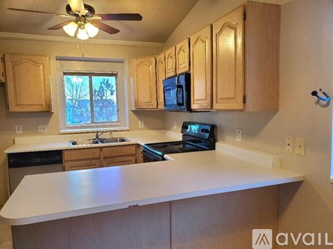 A kitchen with wooden cabinets and a white countertop.