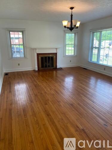 A room with wooden floors and a fireplace.