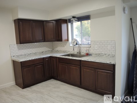 A kitchen with brown cabinets and a white countertop.