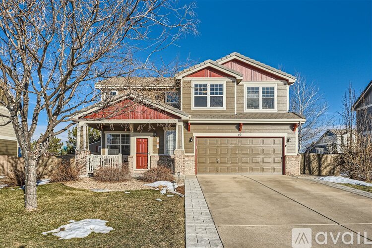 A house with a red door and a garage door is for sale.