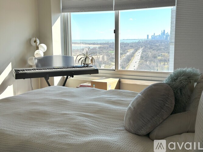 A bedroom with a large bed and a view of the city.