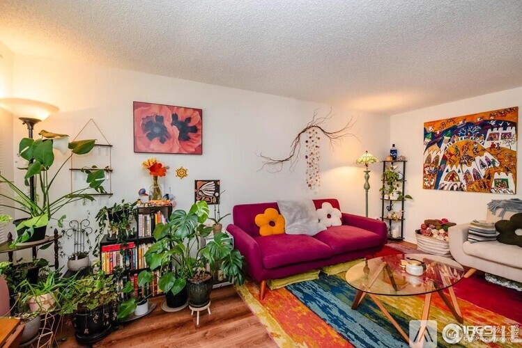 A living room with a red couch and a coffee table.