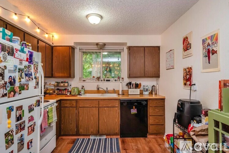 A kitchen with wooden cabinets and a white fridge.