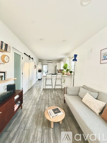 A living room with a grey couch and a wooden coffee table.