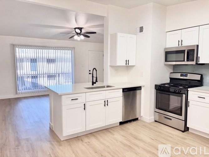 A kitchen with white cabinets and stainless steel appliances.