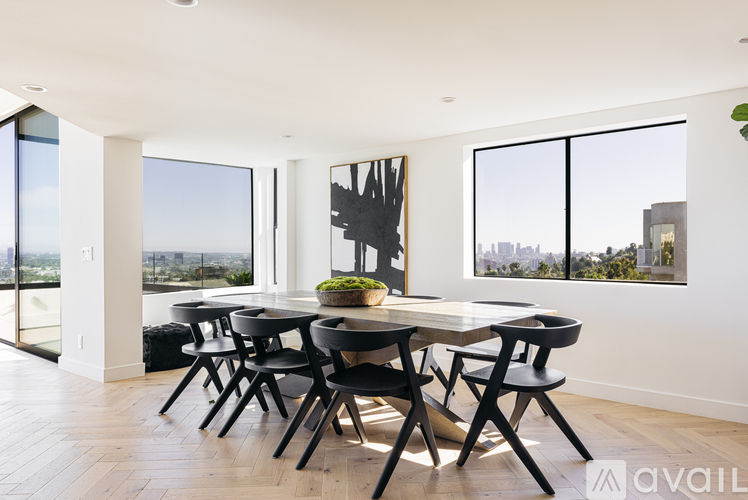 A modern dining room with a large table and chairs.