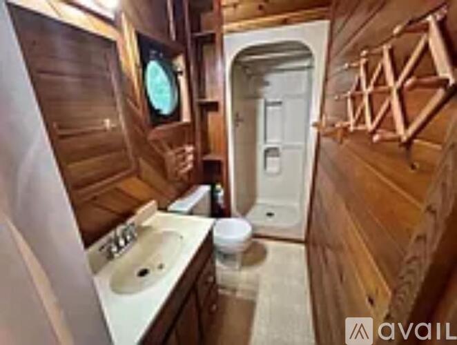 A bathroom with a sink, toilet and mirror.