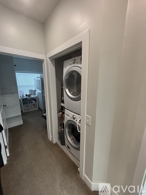 A washing machine is built into a wall in a laundry room.