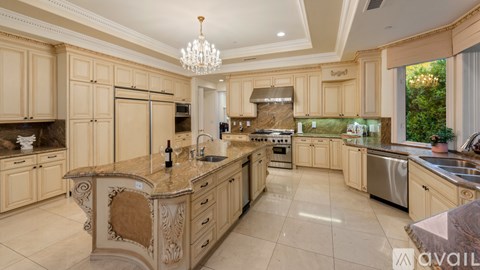 A large, well-equipped kitchen with wooden cabinets and a central island.