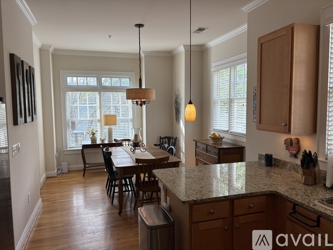 A kitchen with a table and chairs in the middle of the room.