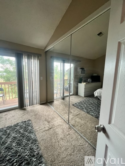 A bedroom with a large mirror and a bed.