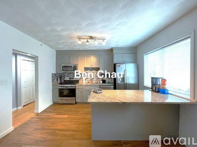 A kitchen with a countertop and a refrigerator.