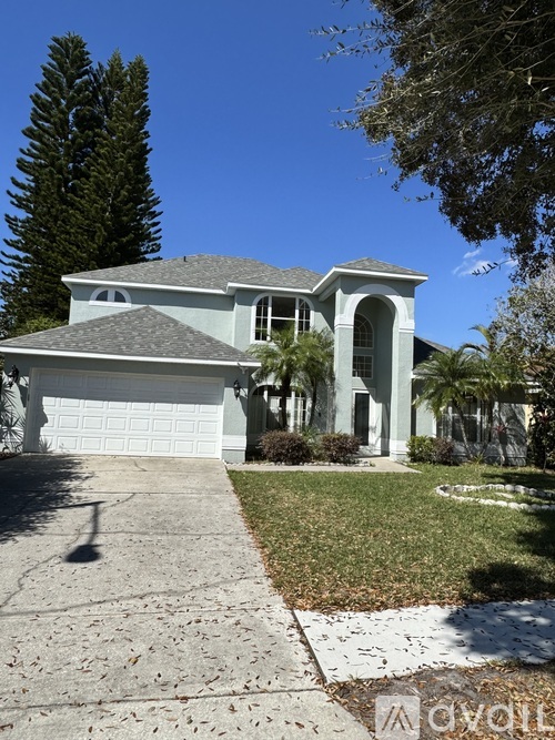 A house with a white garage door and a grey roof.