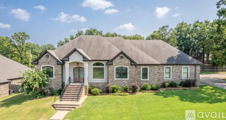 A house with a thatched roof is available for sale.
