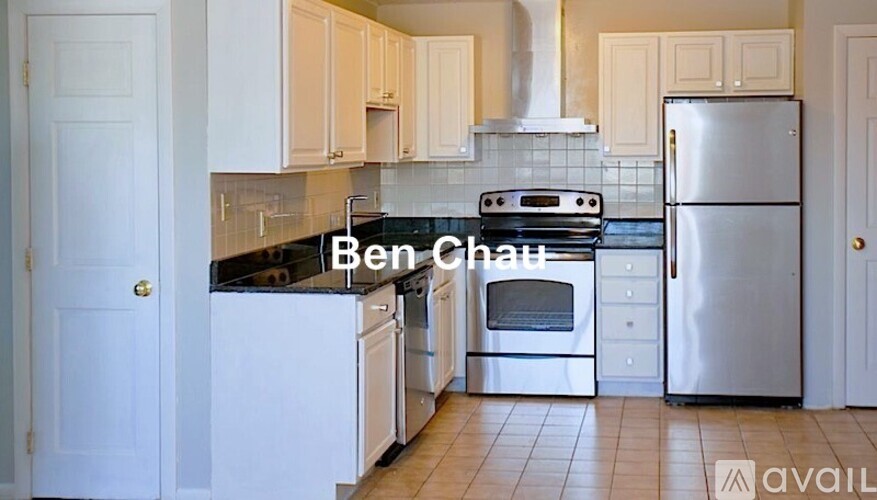 A kitchen with a stove top oven and a refrigerator.