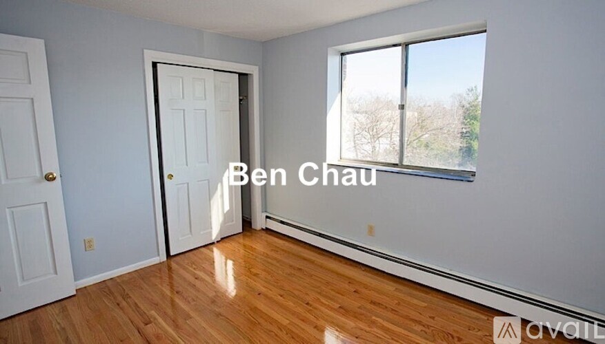 A room with a wooden floor and a large window.