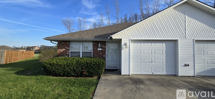 A house with a white garage door is for sale.