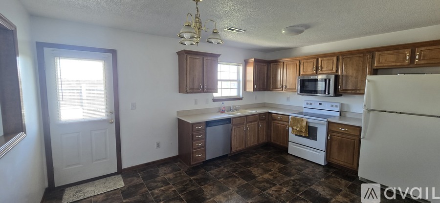 A kitchen with a white refrigerator and a white stove top oven.