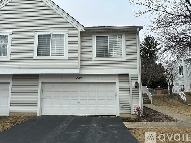 A two-story house with a garage and the number 904 on the side.
