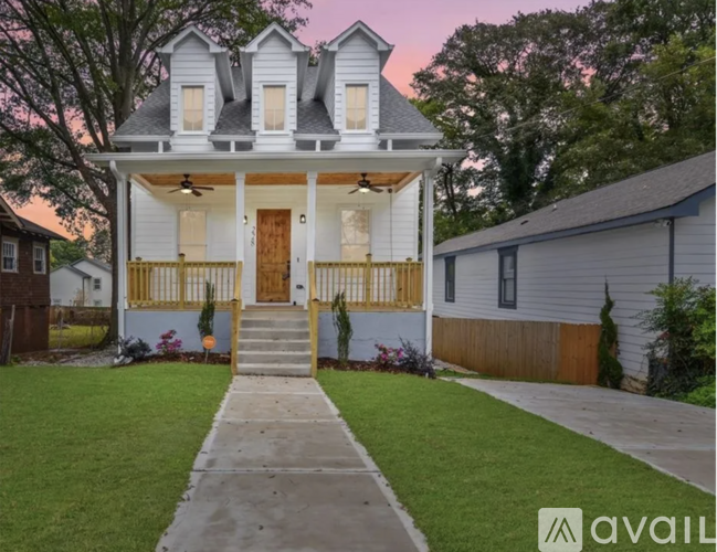 A house with a front porch and a small front yard.