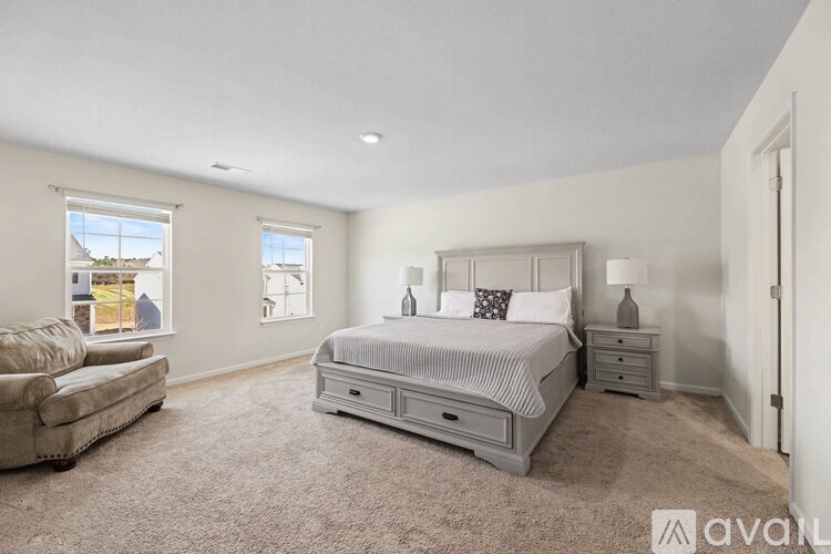 A bedroom with a large bed and a couch.