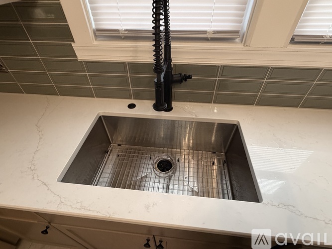 A kitchen sink with a drain in the middle of it.