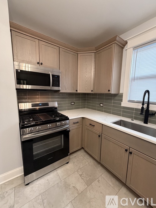 A kitchen with a stove, oven, and cabinets.