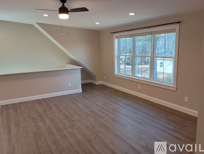 A room with a staircase and a window.