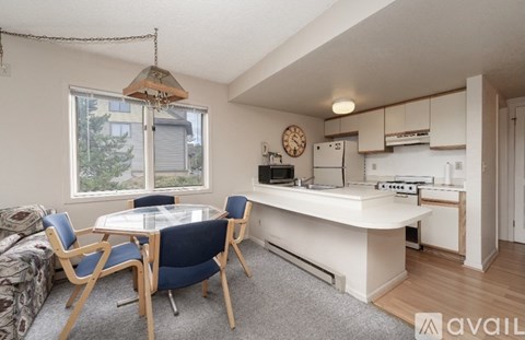 A kitchen area with a table and chairs is available for rent.