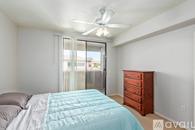 A bedroom with a bed, dresser, and window.