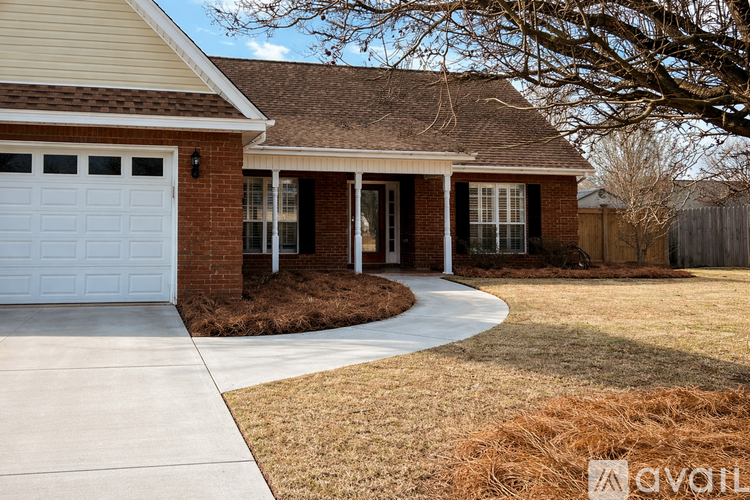 A house with a white garage door and a brown roof.