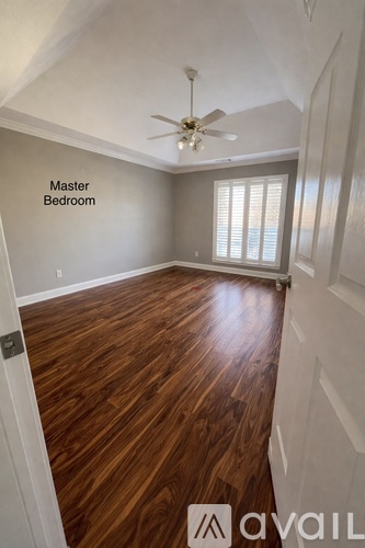 A room with wooden flooring and a ceiling fan is labeled as the master bedroom.