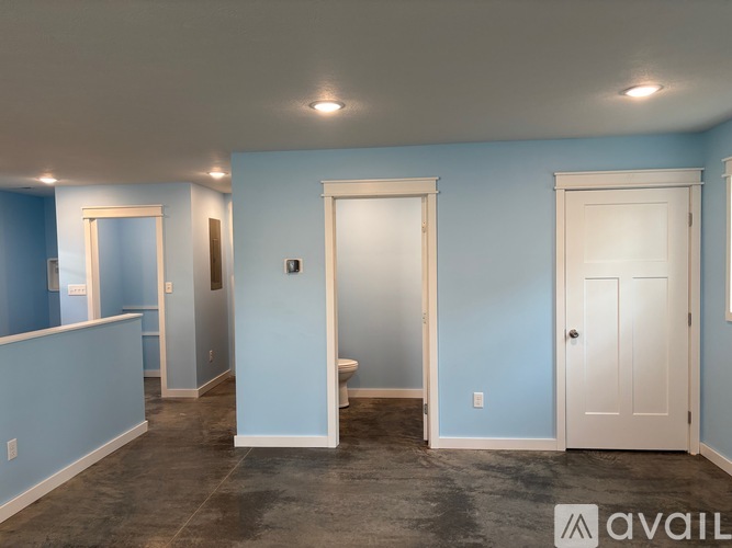 A room with blue walls and a white door.