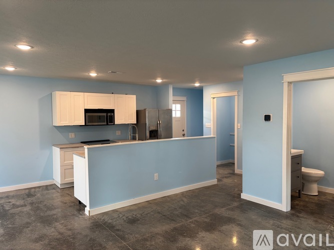 A kitchen with blue walls and a white counter.