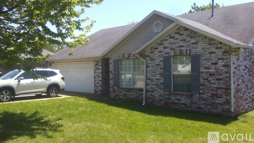 A house with a car parked in front.