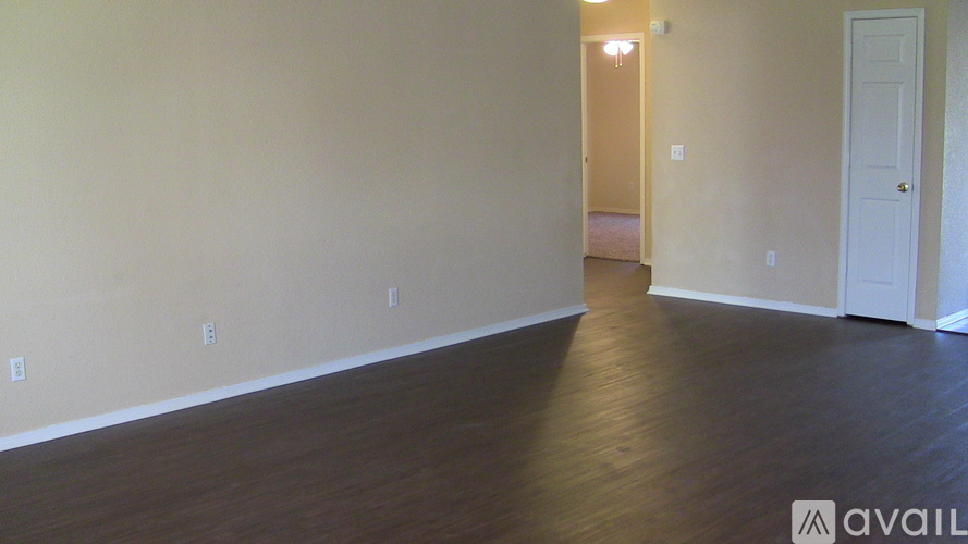 A room with wooden floors and a white door.