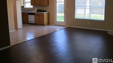 A kitchen with wooden cabinets and a dining table is available for rent.